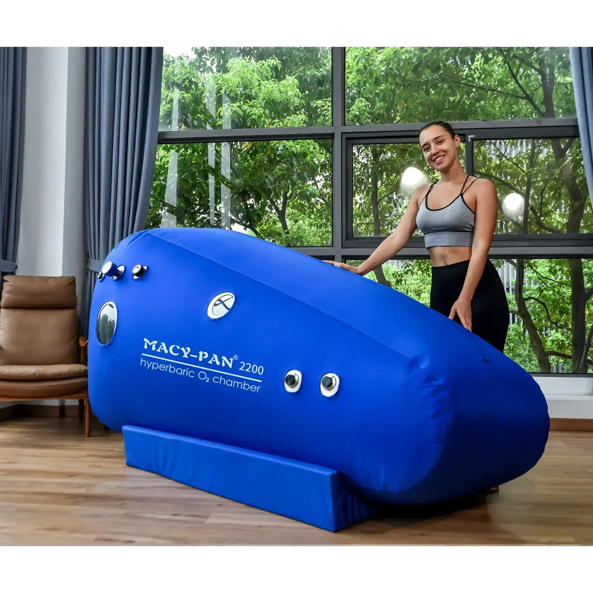 Macy-Pan ST2200 Hyperbaric Oxygen Therapy Chamber in a bright room, designed for seated use, promoting recovery and wellness.