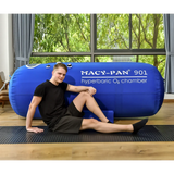 Man resting beside Macy-Pan ST901 hyperbaric oxygen therapy chamber for optimal healing and recovery.