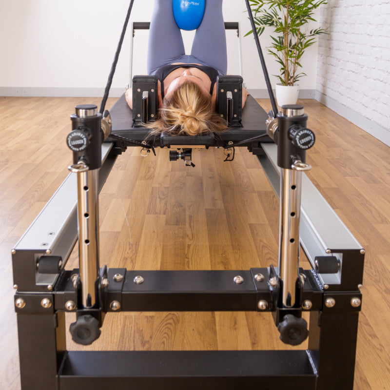 A8-Pro reformer seen head on from the foot bar with a client on the carriage