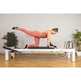 Client using the ropes on the white C8-S Pro reformer