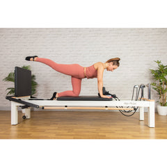 Client using the ropes on the white C8-S Pro reformer