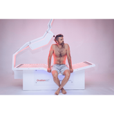 Client reclining in OvationULT therapy bed – ult therapy – RecovAthlete