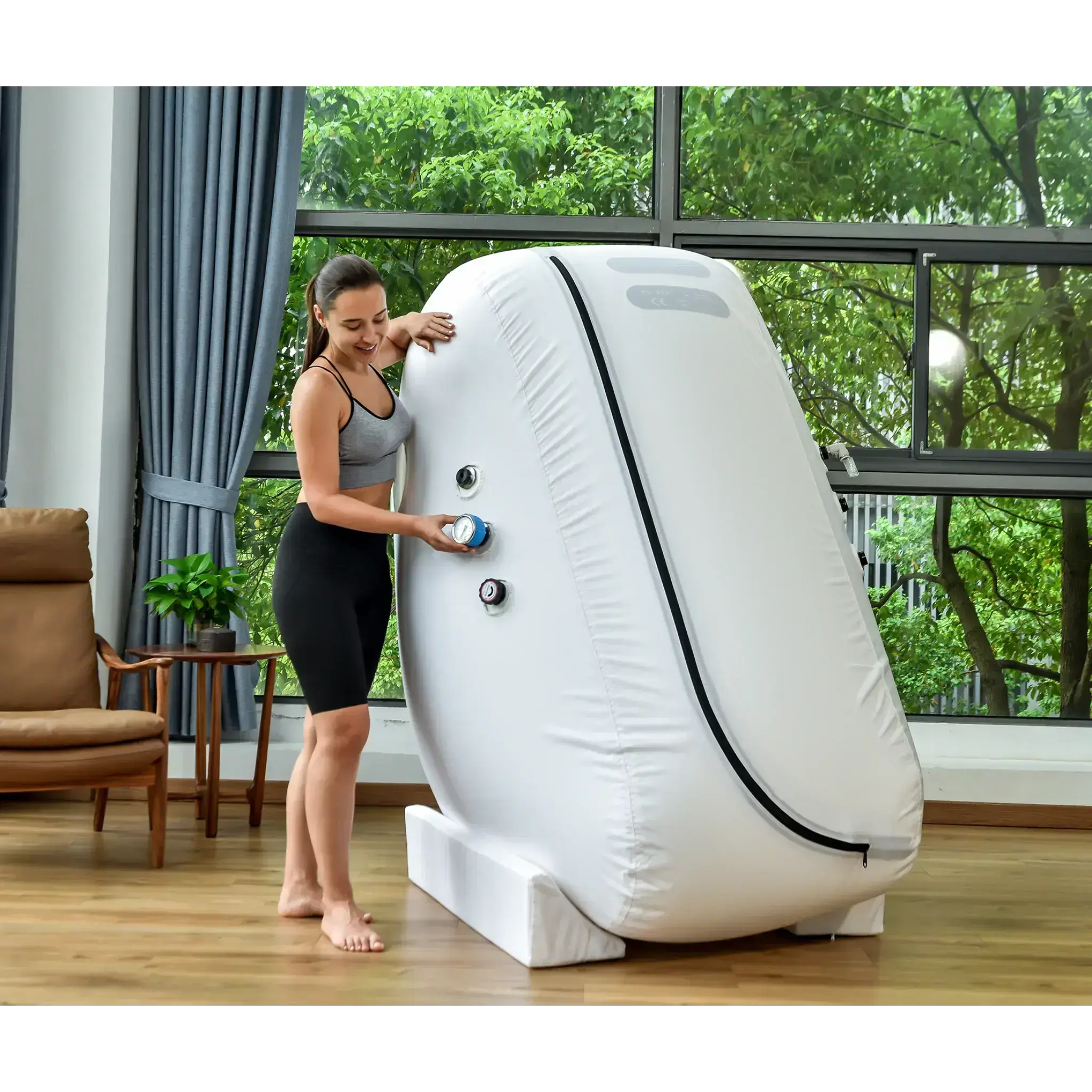 Woman using Macy-Pan L1 Hyperbaric Oxygen Therapy Chamber in a bright, spacious room.