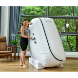 Woman using Macy-Pan L1 Hyperbaric Oxygen Therapy Chamber in a bright, spacious room.