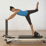 Female athlete doing core exercises on Merrithew SPX Max Reformer