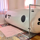 Newtowne C4-40 hyperbaric chamber in a cozy room, featuring spacious design for improved recovery and relaxation.