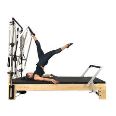 Align Pilates M8-Pro maple reformer with Half Cadillac, instructor working the push through bar, side view