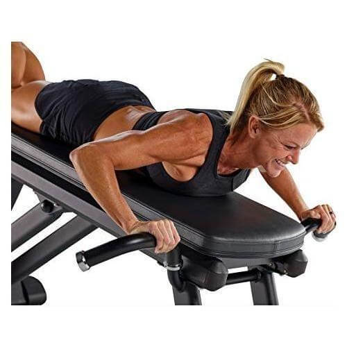 female model doing exercise on Male model working out on Total Gym ELEVATE Press Trainer