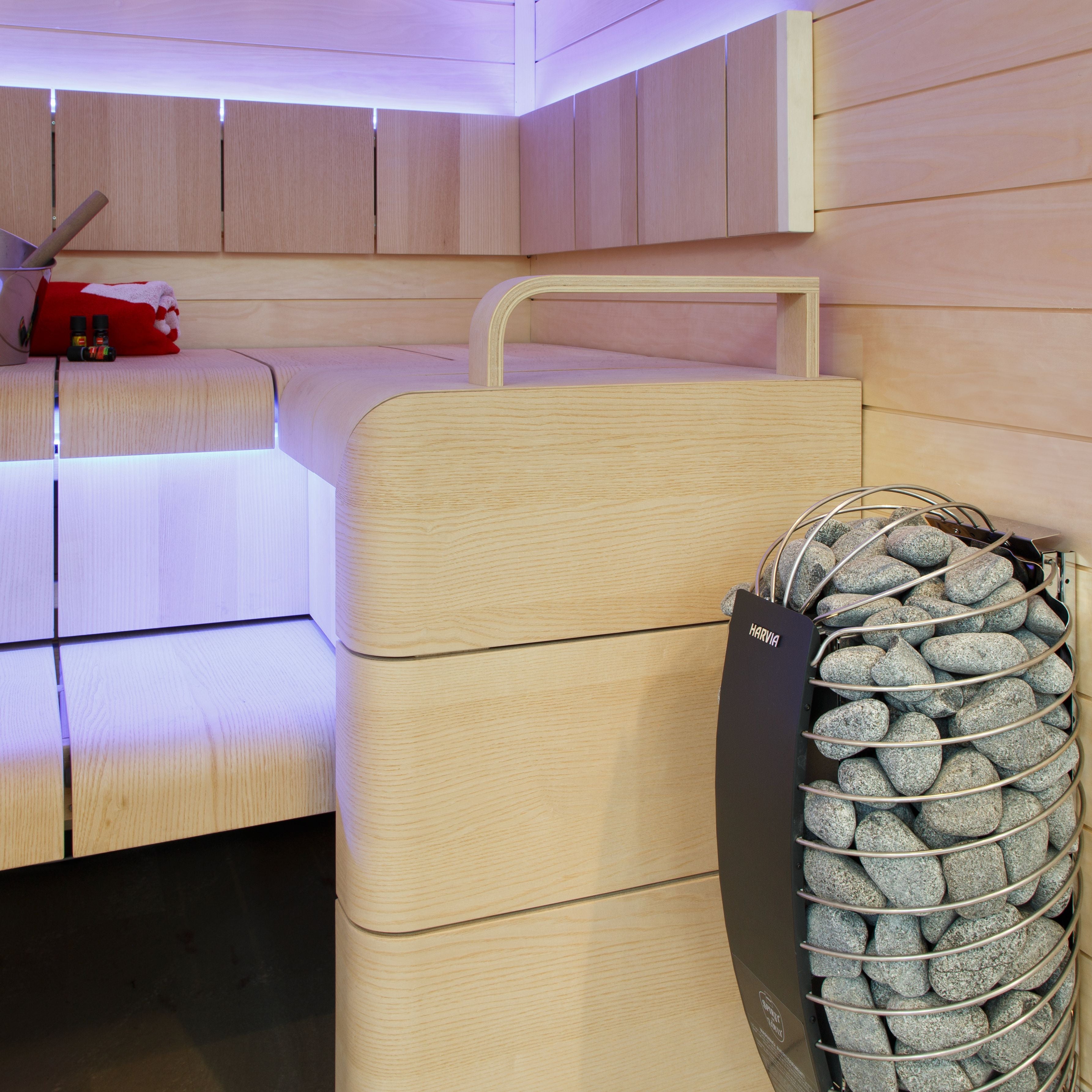 Harvia Spirit sauna heater in a sauna with purple accent lighting