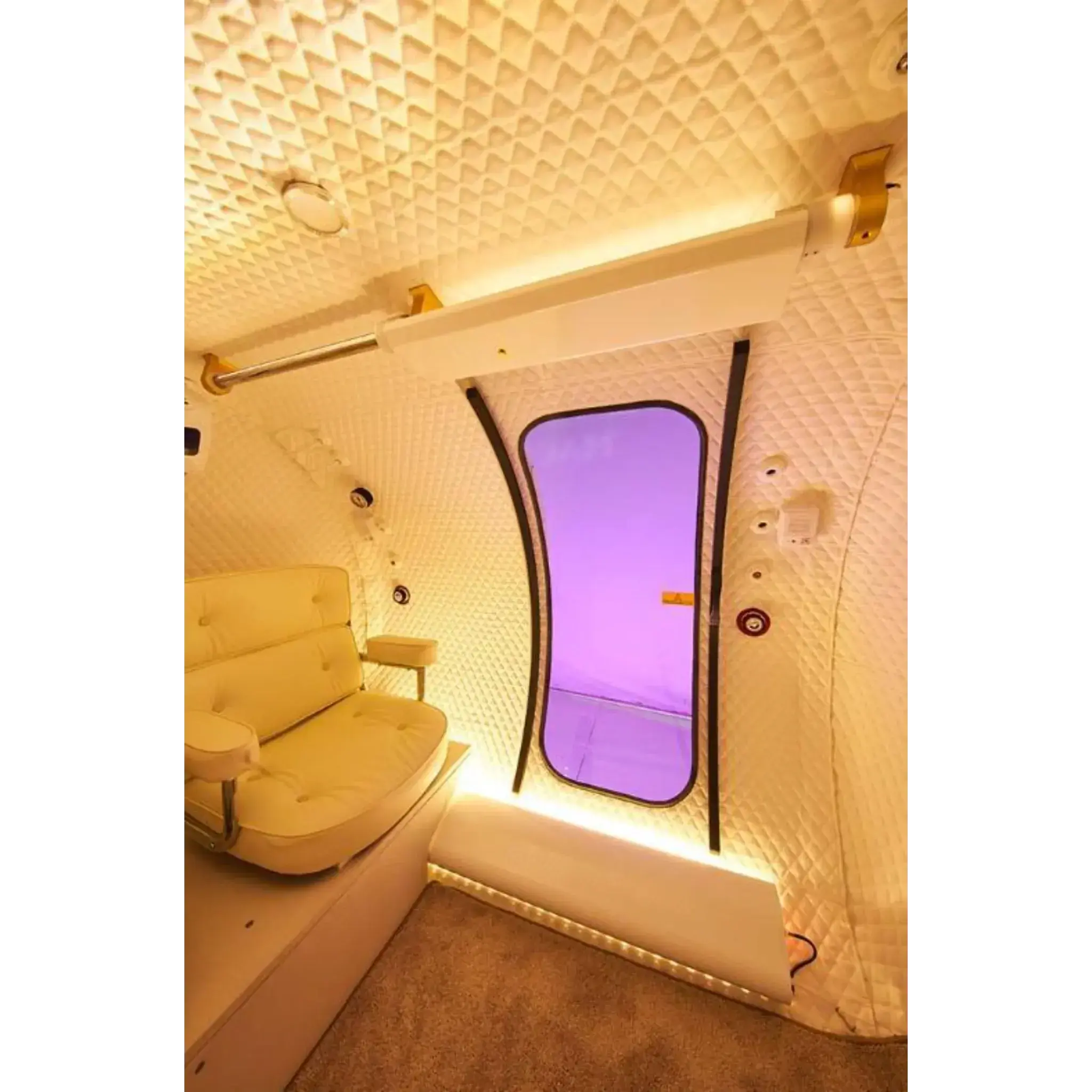 Interior of Macy-Pan HE5000 hyperbaric oxygen therapy chamber with spacious seating and sliding door.