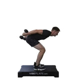 male Model doing dumbell streches on Vibeplate 2440 whole body vibration machines