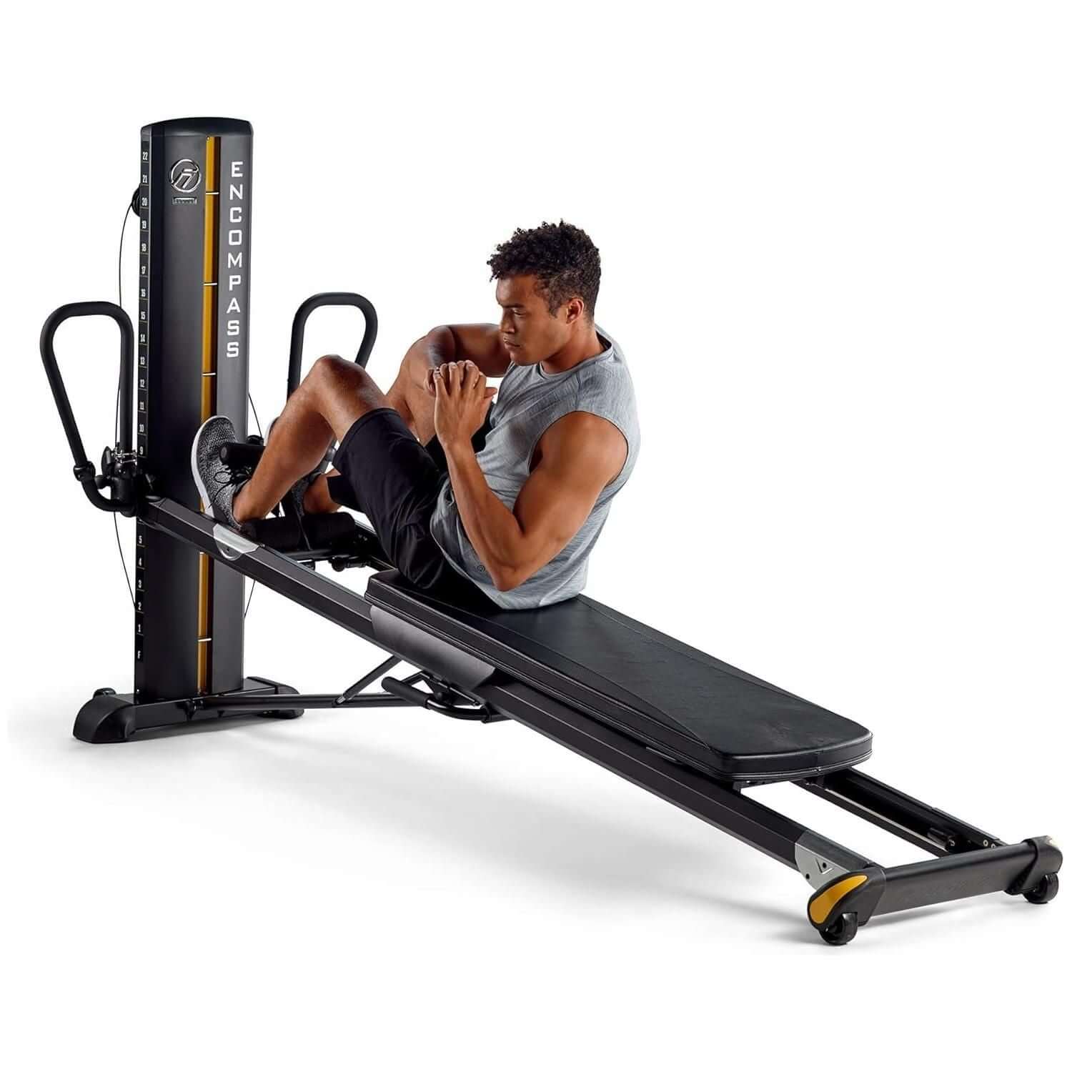 male model doing side extensions on Total Gym ELEVATE Encompass™ Pilates Package