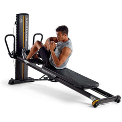 male model doing side extensions on Total Gym ELEVATE Encompass™ Pilates Package