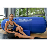 Macy-Pan ST702 Hyperbaric Oxygen Therapy Chamber with a woman sitting beside it, showcasing wellness and recovery benefits.