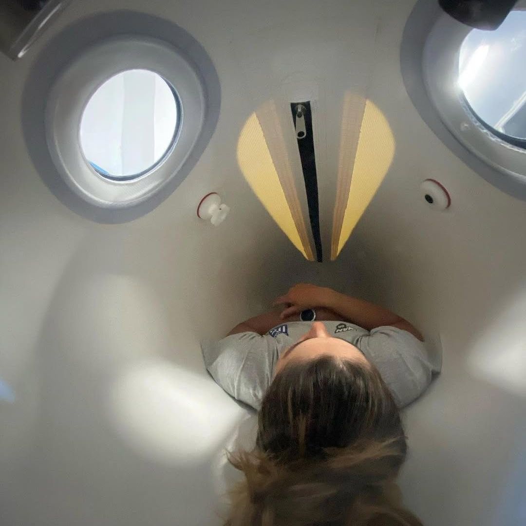 women lying down inside of Oxynova 8 chamber