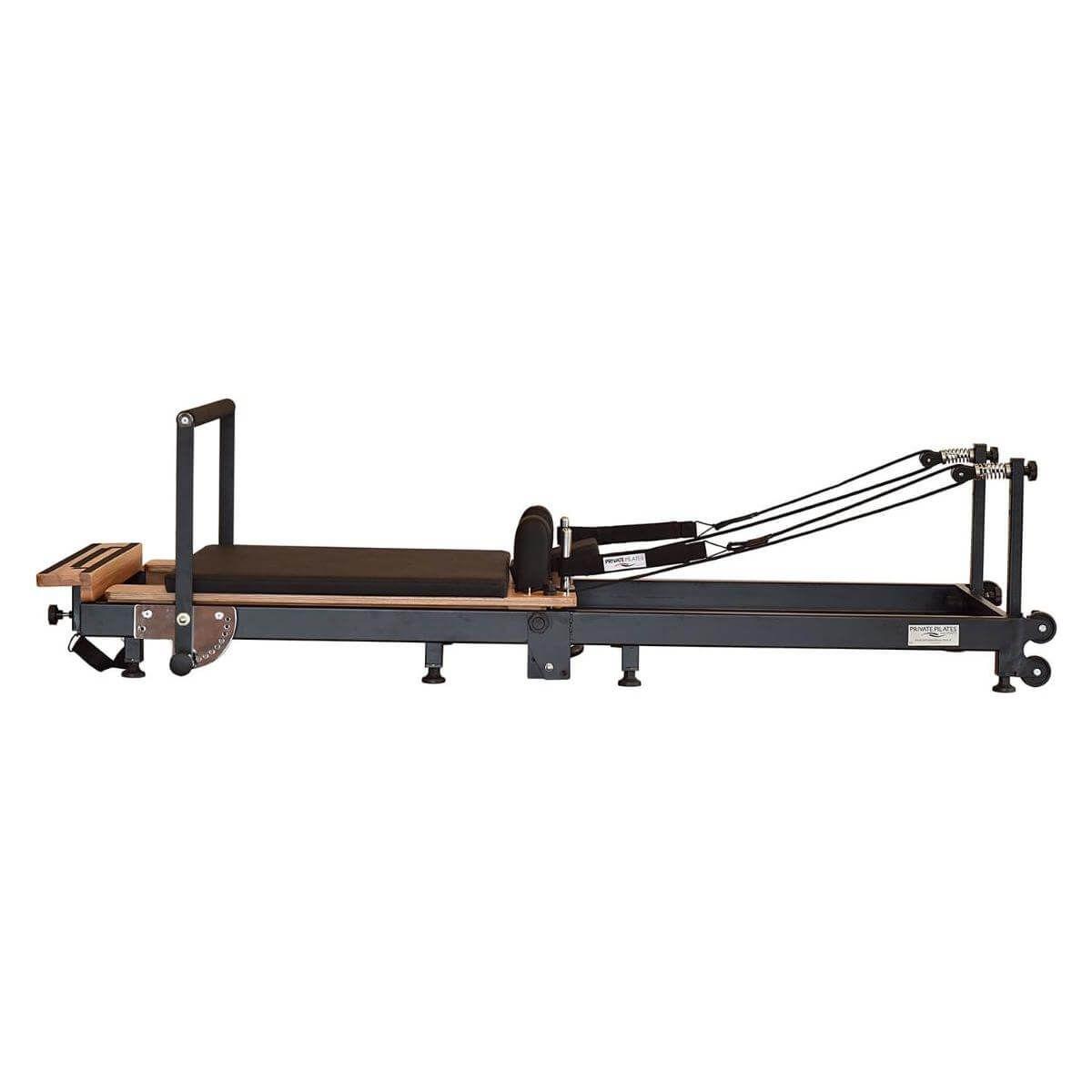 Private Pilates Premium Foldable Metal Reformer with wooden frame for strength and rehabilitation exercises.