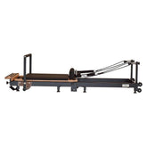 Private Pilates Premium Foldable Metal Reformer with wooden frame for strength and rehabilitation exercises.