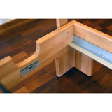 Close-up view of Private Pilates premium foldable metal reformer, showcasing wooden frame craftsmanship.