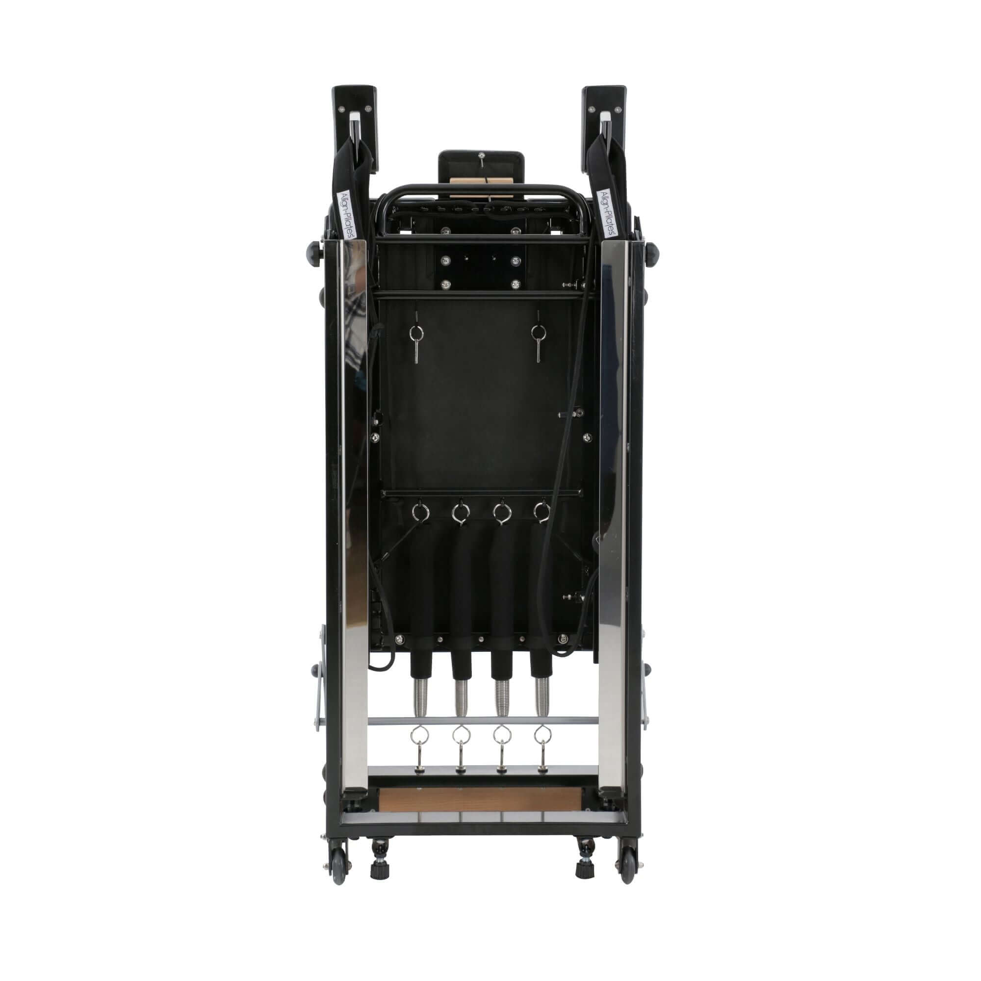 Folded Align Pilates F2 Reformer in a storage space, highlighting its compact size and portability.