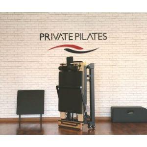 Foldable Basi Pilates Reformer with wooden frame in Private Pilates studio setting, emphasizing strength and wellness.