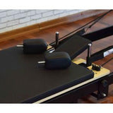 Close-up of Private Pilates premium foldable metal reformer cushion and adjustments for comfortable workouts.