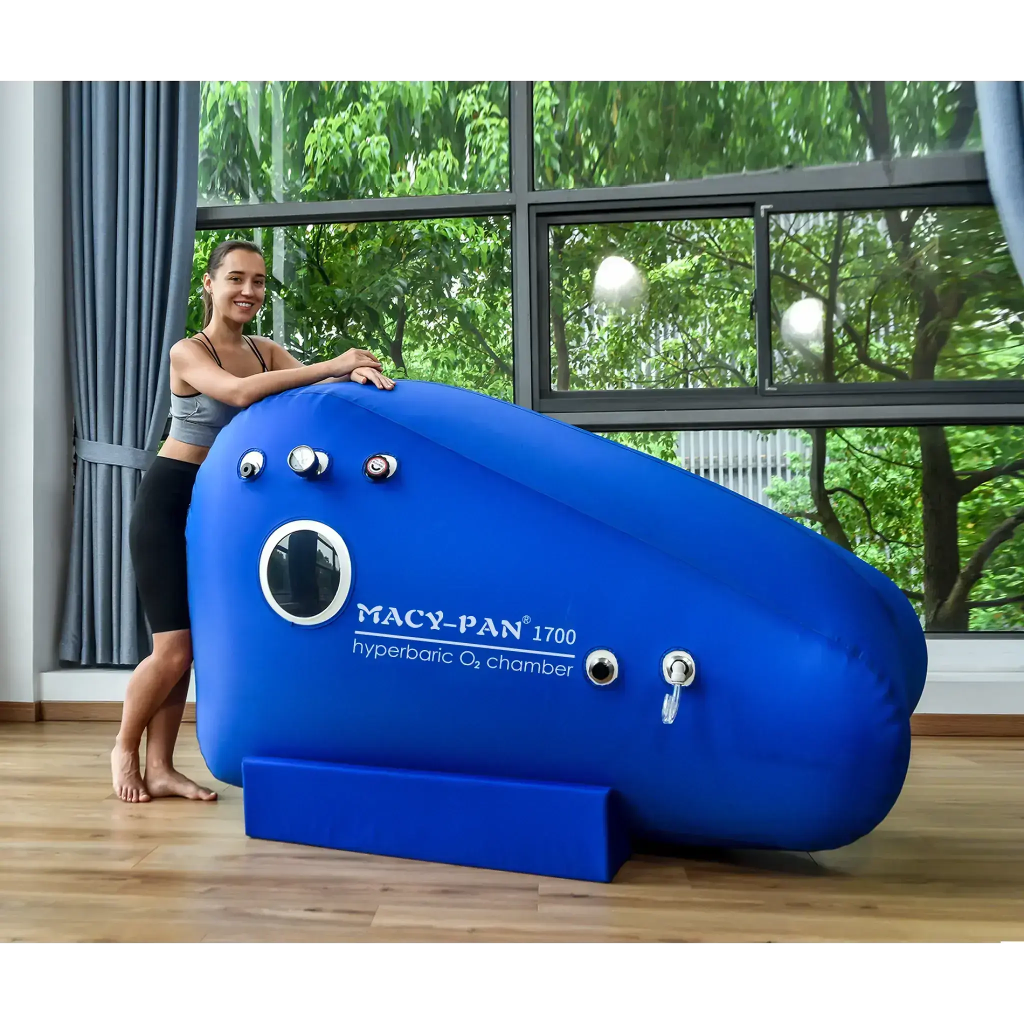 Macy-Pan ST1700 hyperbaric oxygen therapy chamber in a home setting, with a woman demonstrating its use.