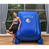 Woman beside Macy-Pan 4000 hyperbaric oxygen chamber showcasing its innovative design.