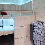 Harvia Spirit sauna heater installed in a light wood sauna with blue accent lighting