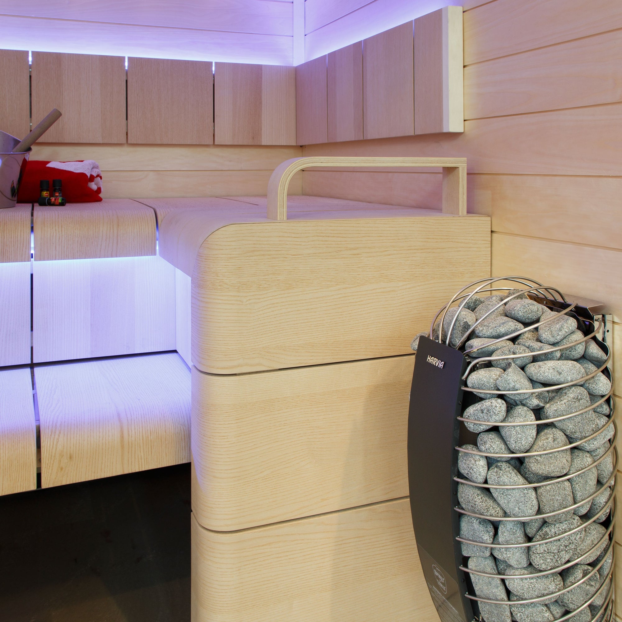 Harvia Spirit sauna heater in a sauna with purple accent lighting