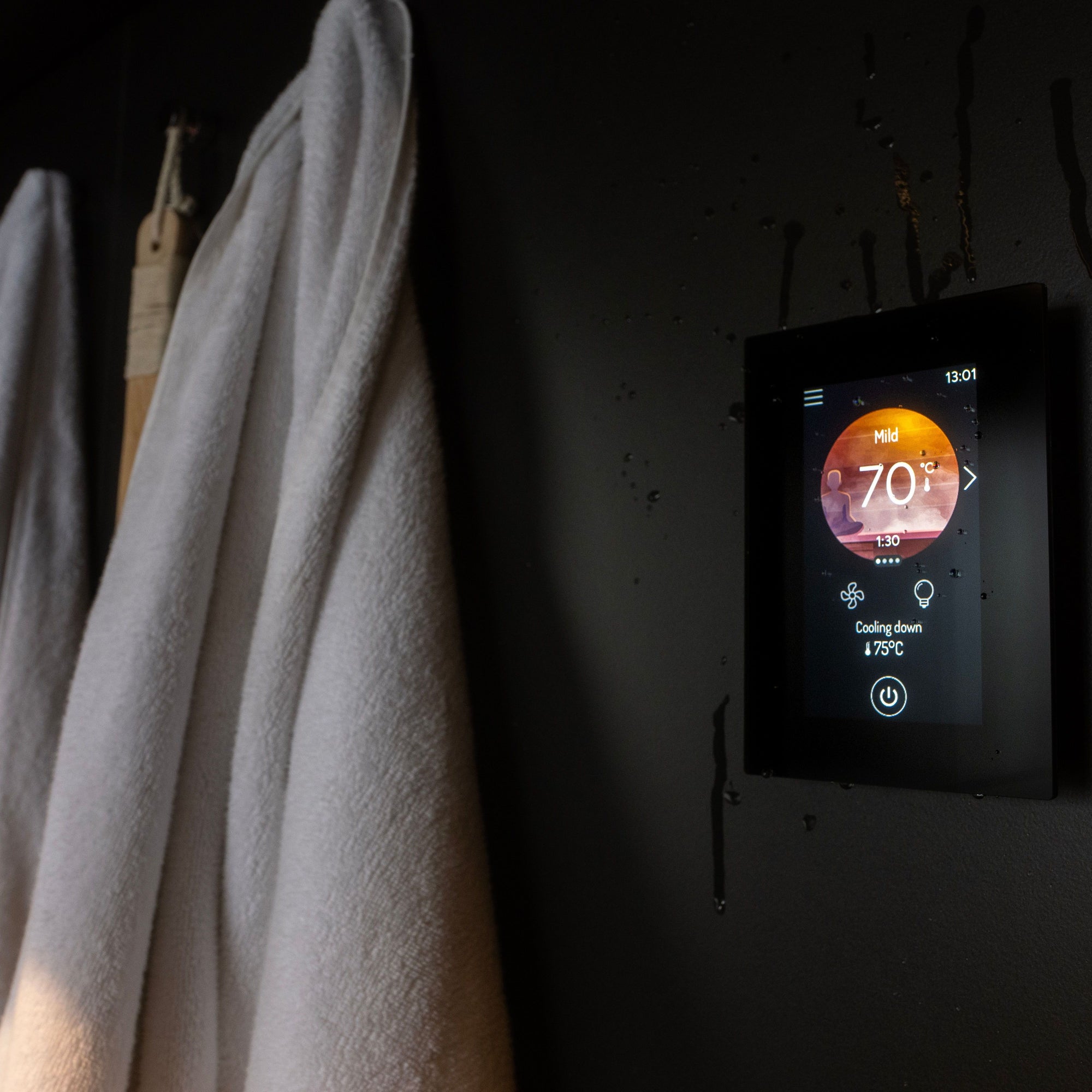 Harvia Fenix FX001XW WiFi control panel lit on a dark sauna wall