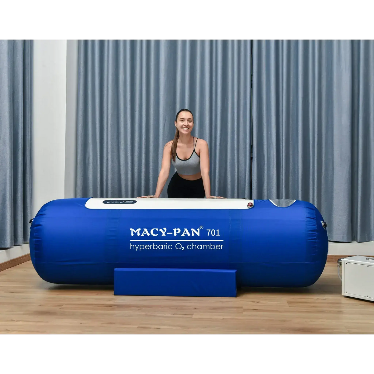 Macy-Pan ST701 hyperbaric oxygen therapy chamber with a smiling woman promoting wellness and recovery.