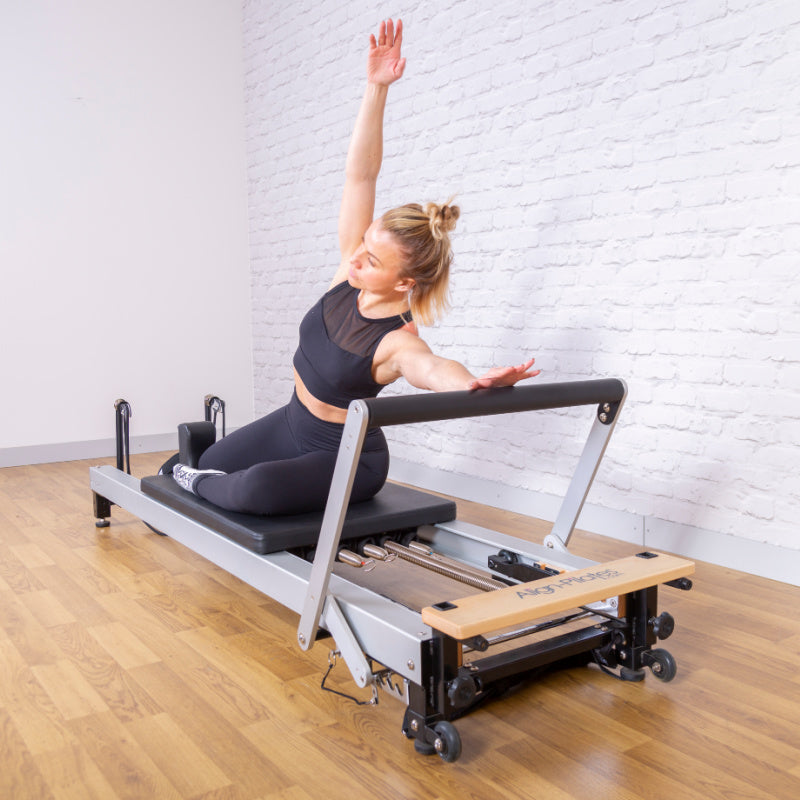 C8-Pro reformer at a diagonal with a client in a kneeling position