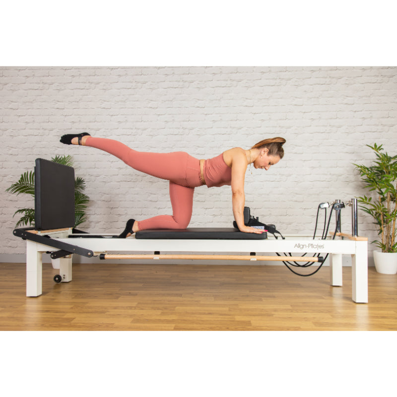 Client using the ropes on the white C8-S Pro reformer