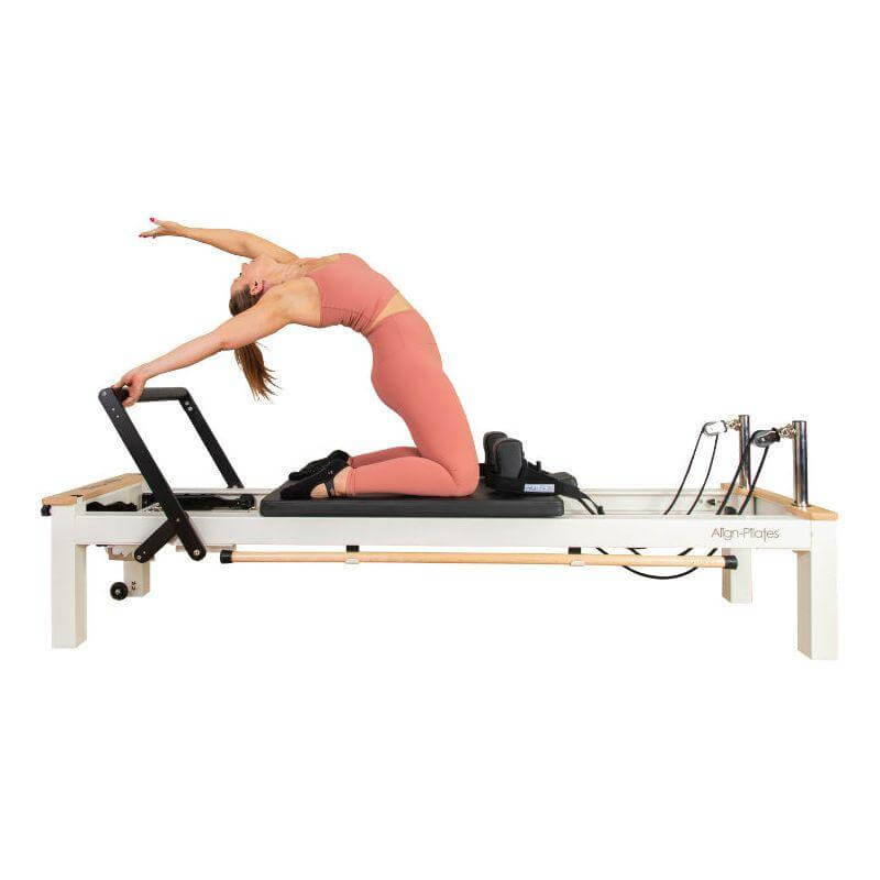 Align Pilates C8-S Pro white reformer in use, side angle showing carriage travel
