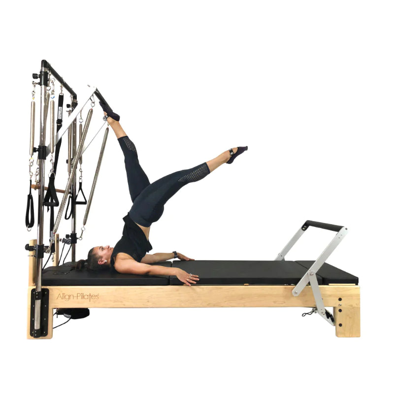Align Pilates M8-Pro maple reformer with Half Cadillac, instructor working the push through bar, side view