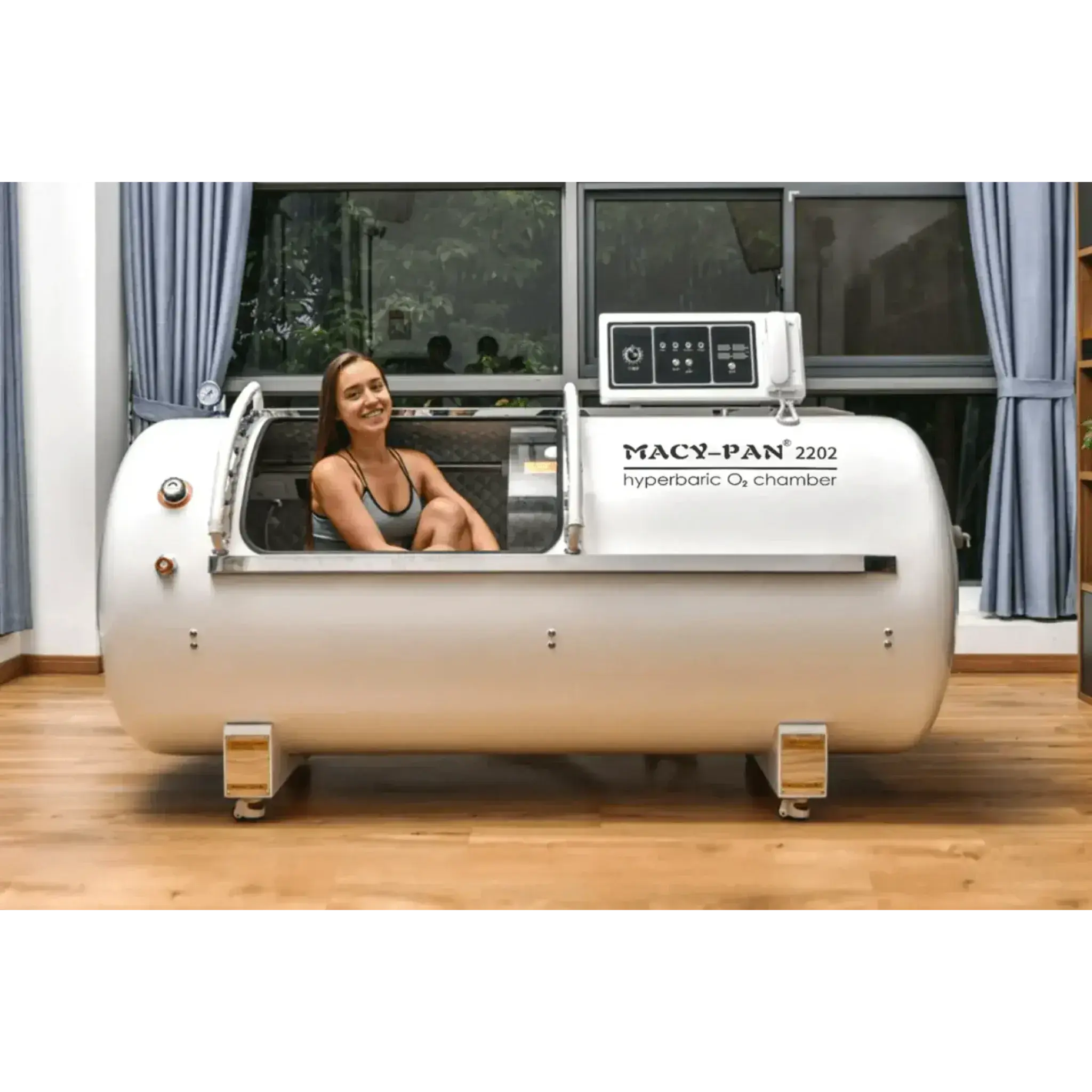 Macy-Pan HP2202 hyperbaric oxygen chamber with a user seated inside, designed for recovery and healing.