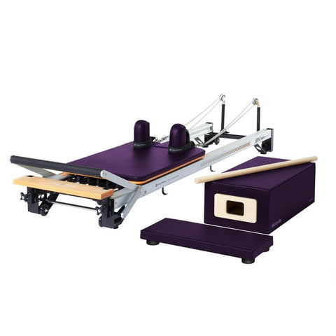 A vibrant and energetic representation of the MERRITHEW PILATES V2 MAX REFORMER in Purple Impulse, showcasing an electric purple color that is both bold and striking