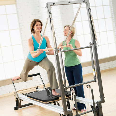 Woman engaged in Pilates session on Merrithew SPX Max Plus Reformer bundle