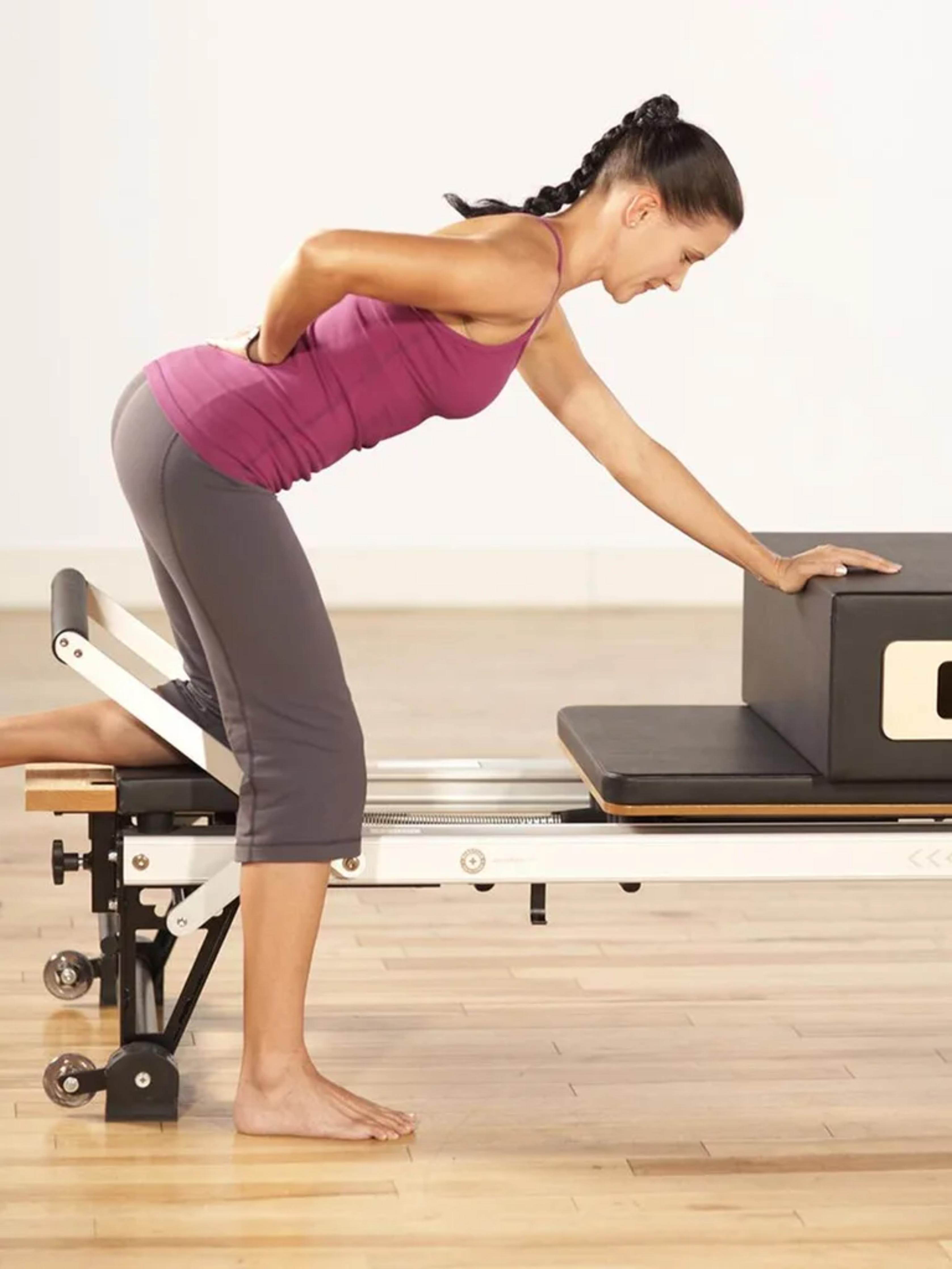 Woman working out on Merrithew SPX Max Plus Reformer Bundle