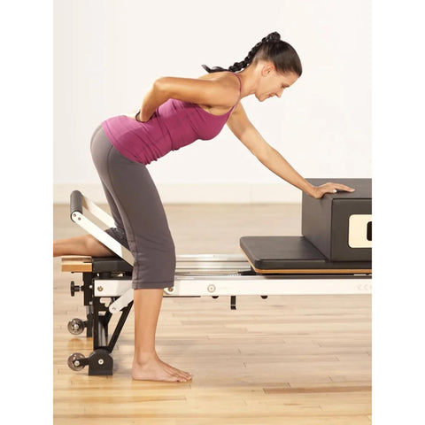 Woman working out on Merrithew SPX Max Plus Reformer Bundle