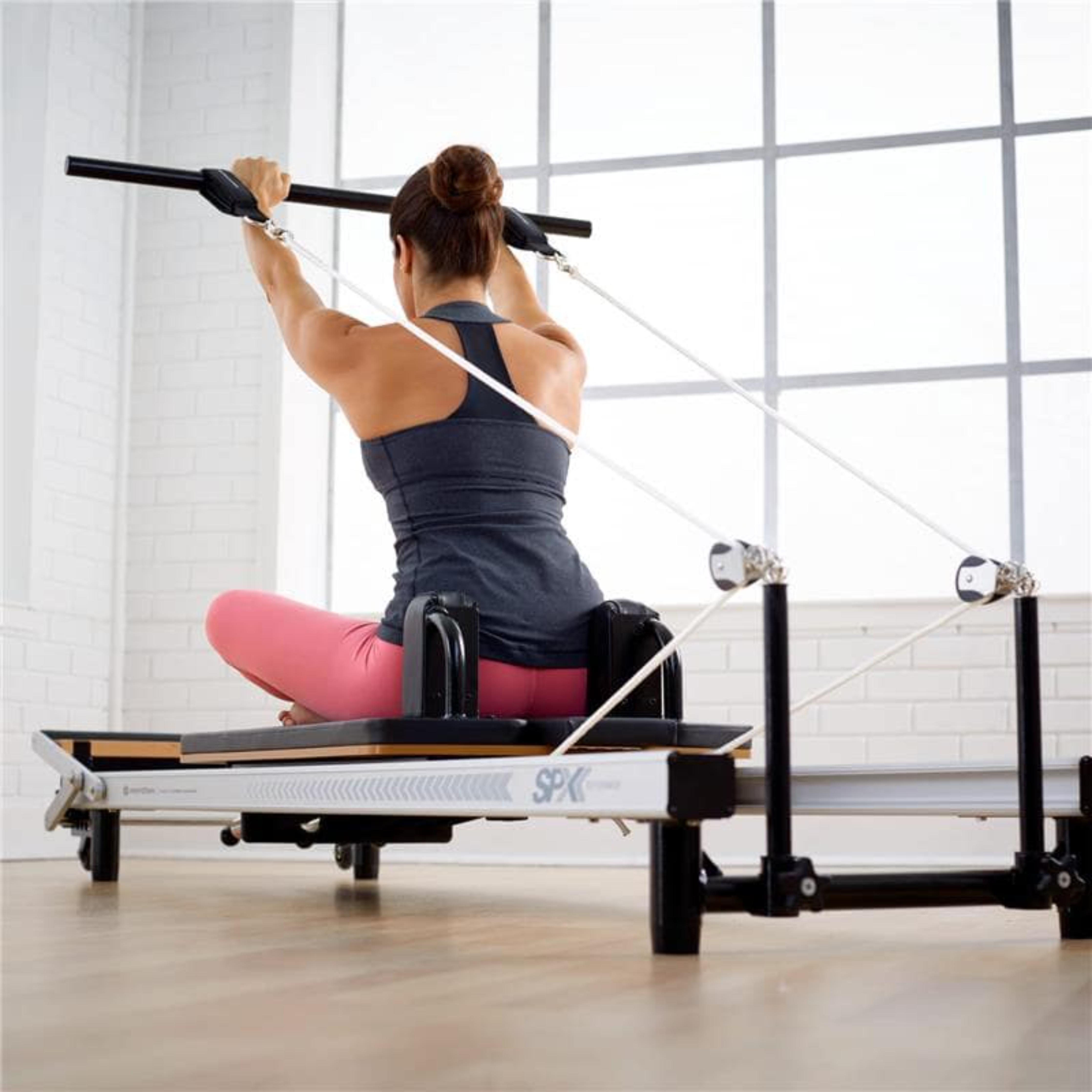 Woman engaging in lower body sculpting on Merrithew SPX Max Reformer