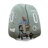 Person using a portable oxygen chamber with OxyRevo Heal40 1.4 ATA Wheelchair Hyperbaric Chamber on a white background