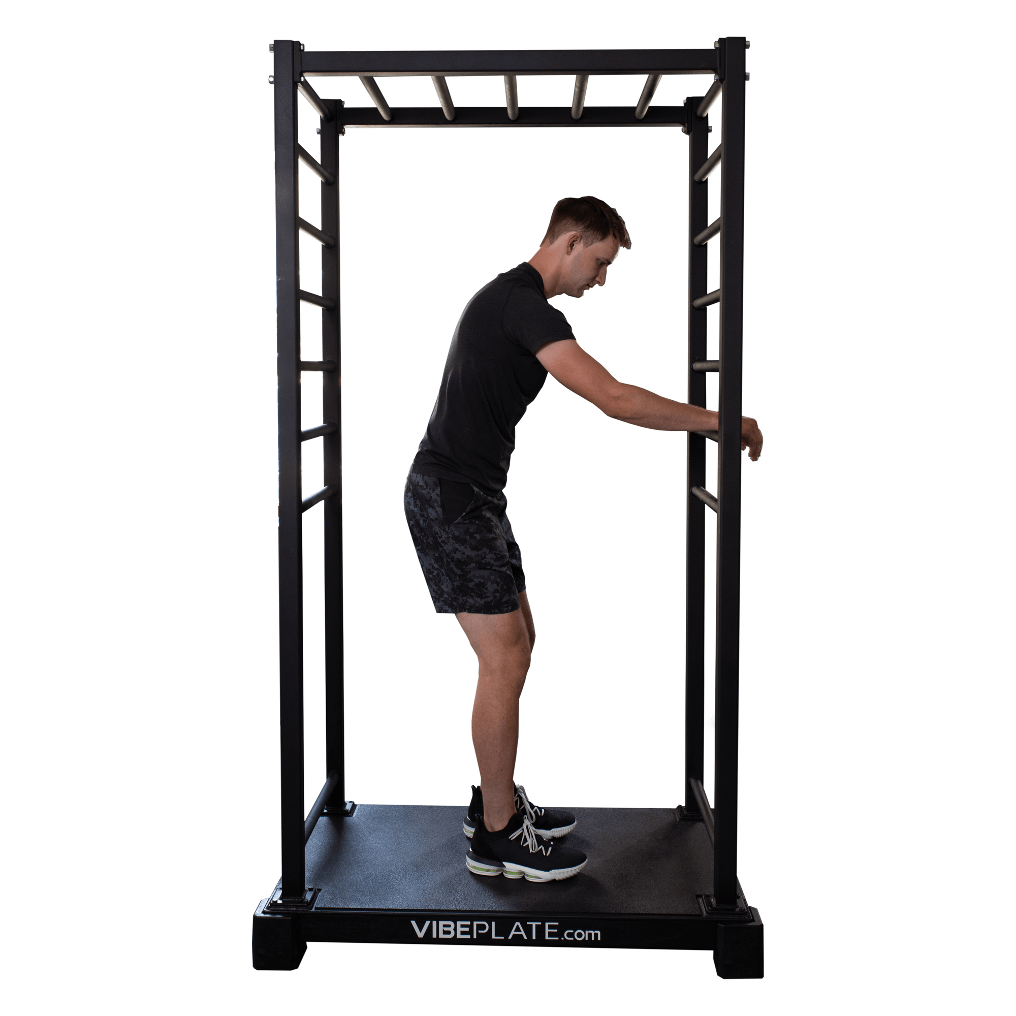 Side view of man holding VibePlate VibeStretch platform for stability, engaging in a warm-up stretch exercise