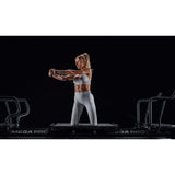 Woman using Lagree Mega Pro reformer during workout – rear platform with handlebars – RecovAthlete