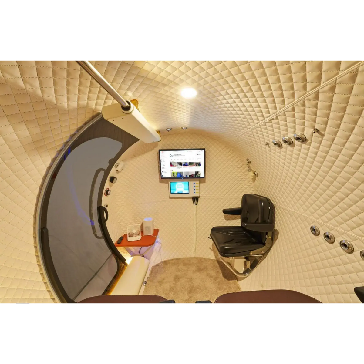 Interior view of Macy-Pan HE5000 Hyperbaric Oxygen Therapy Chamber with seating and control panel.