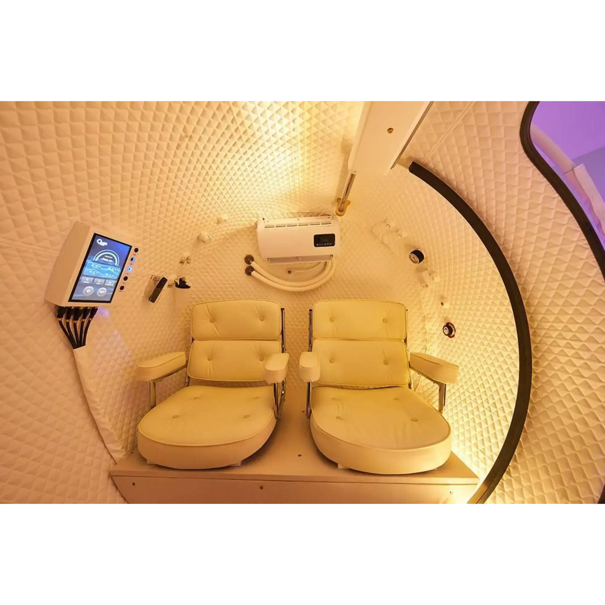Interior of the Macy-Pan HE5000 Hyperbaric Oxygen Therapy Chamber with two reclined seats.