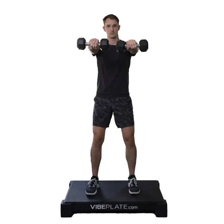 male Model doing dumbell exercises on Vibeplate 2440 whole body vibration machines