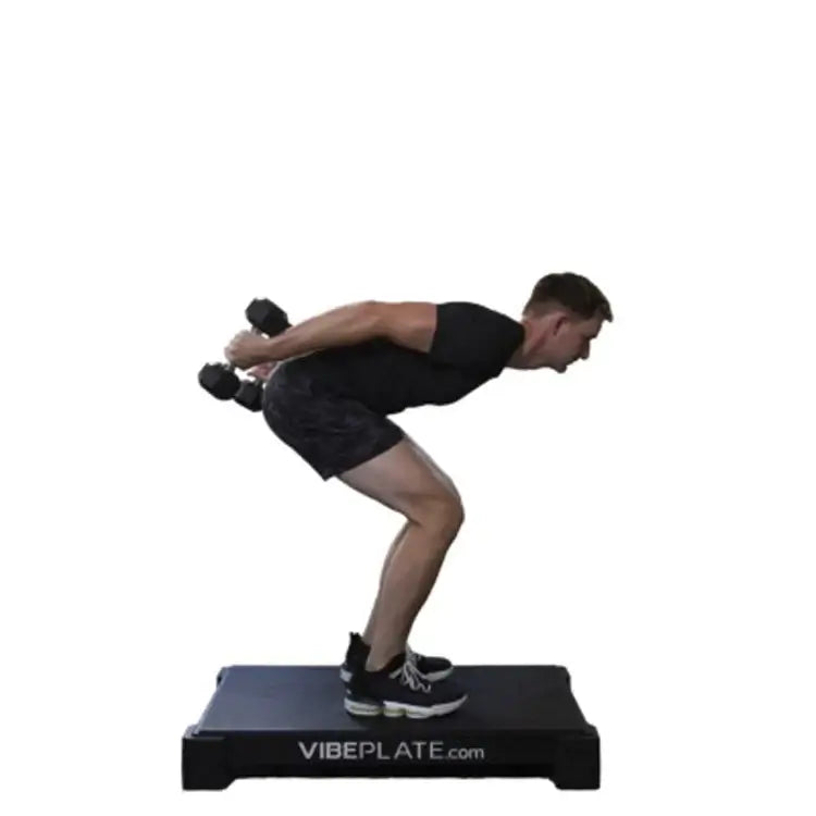 male Model doing dumbell streches on Vibeplate 2440 whole body vibration machines