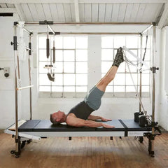 Pilates instructor using Align Pilates C8 Pro Cadillac Combo