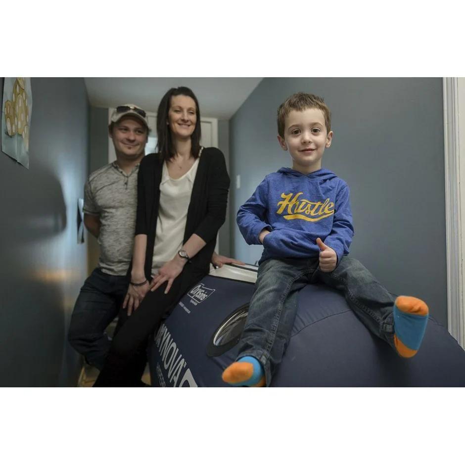 Family with child sitting on Oxynova 7 portable hyperbaric chamber.